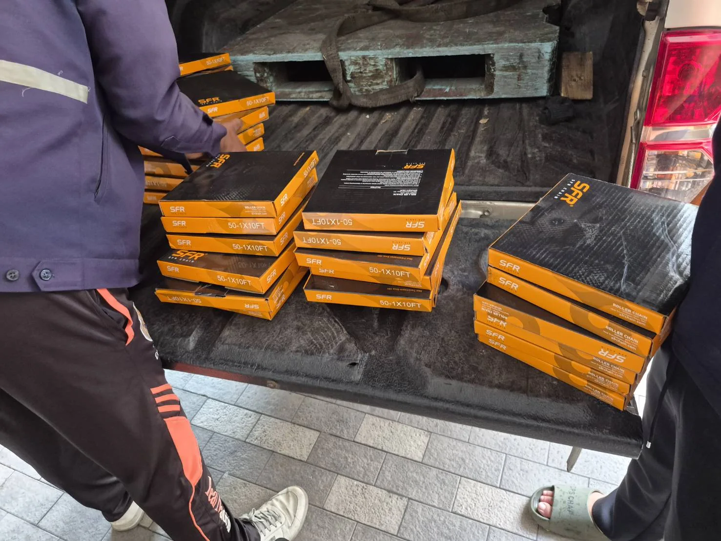 Large-scale chain shipment — flatbed truck loaded with Bangkok-stamped wooden export crates